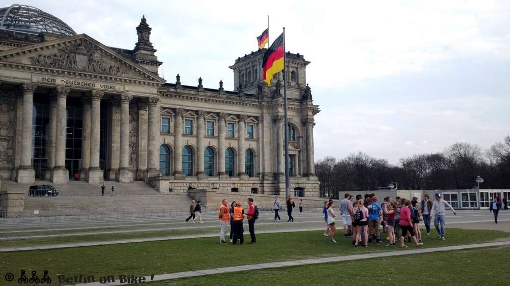 a group of people standing in front of a large building