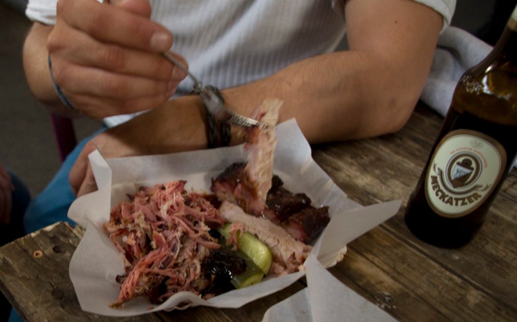 a person sitting at a table eating food