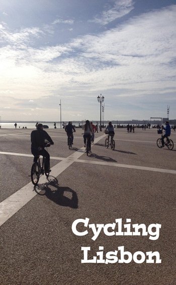radtour-lissabon-pinterest a group of people riding bikes on a road