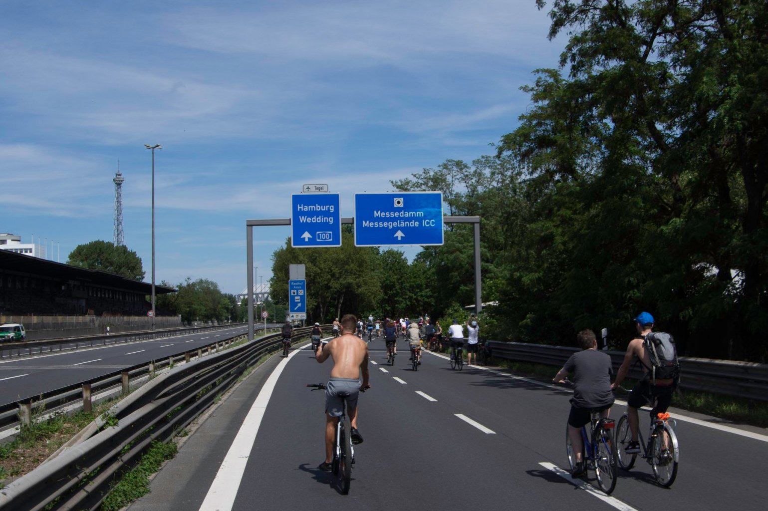 a group of people riding bikes down a highway