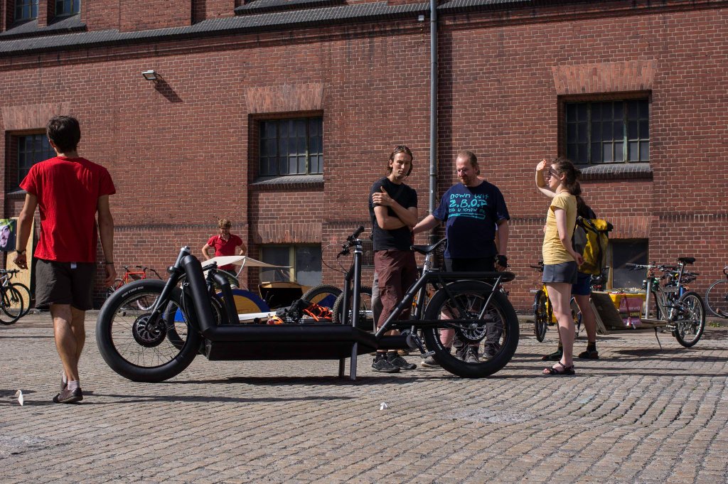 a person riding a bicycle in front of a building