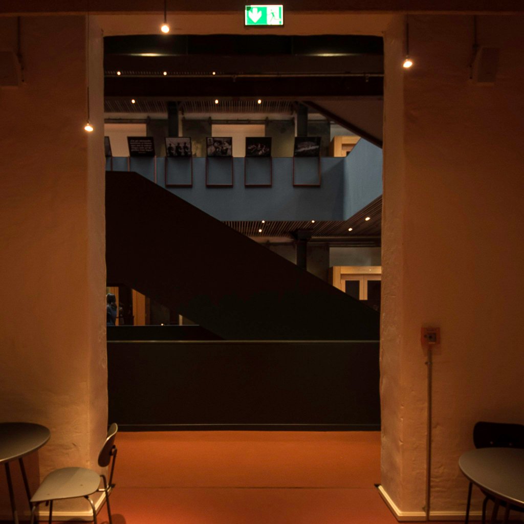 a person sitting at a table in a dark room
