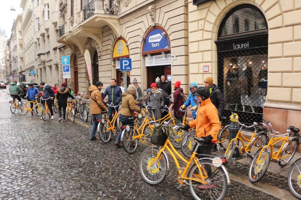 a group of people standing in front of a bicycle