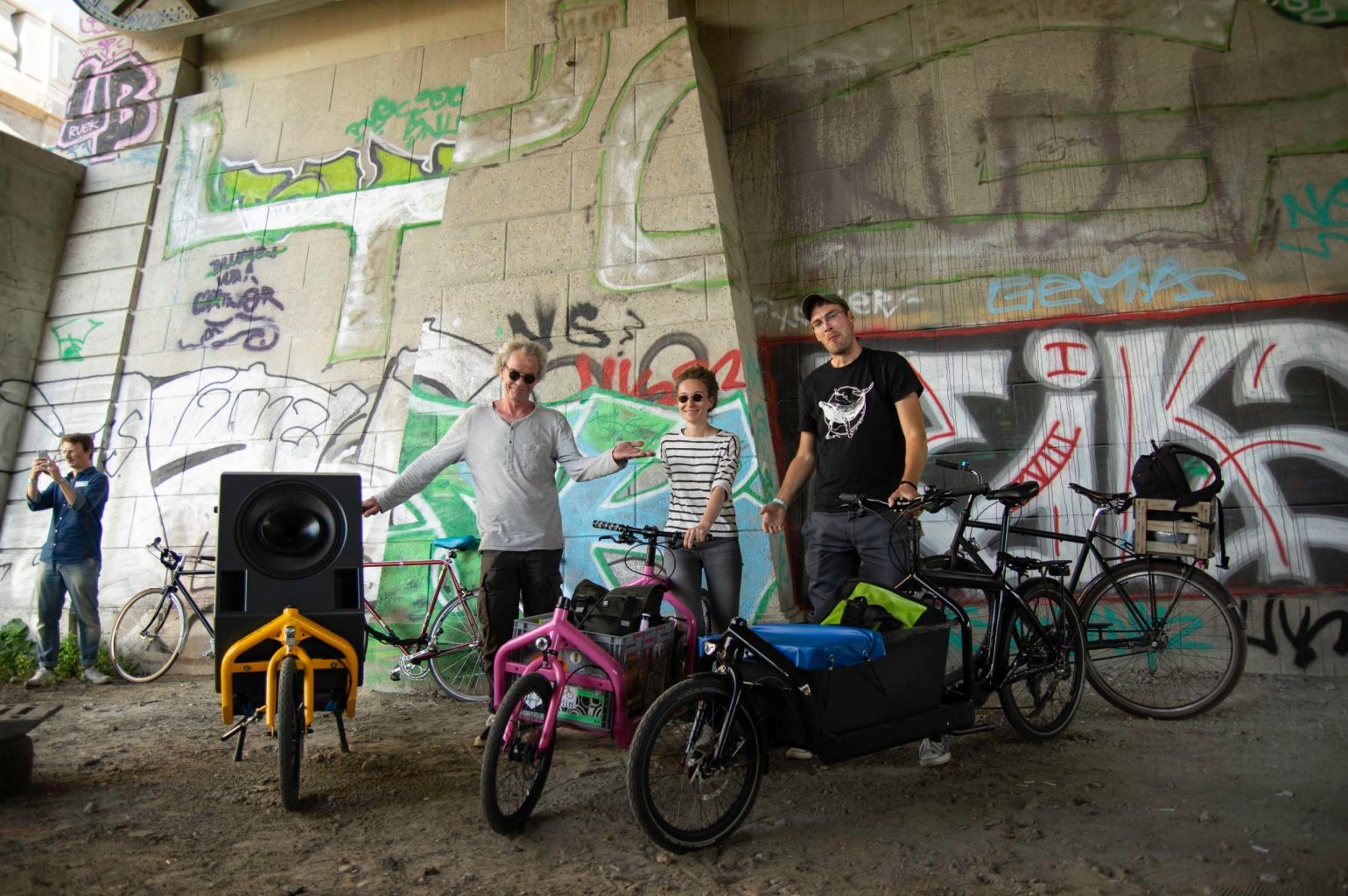 a group of people riding on the back of a bicycle