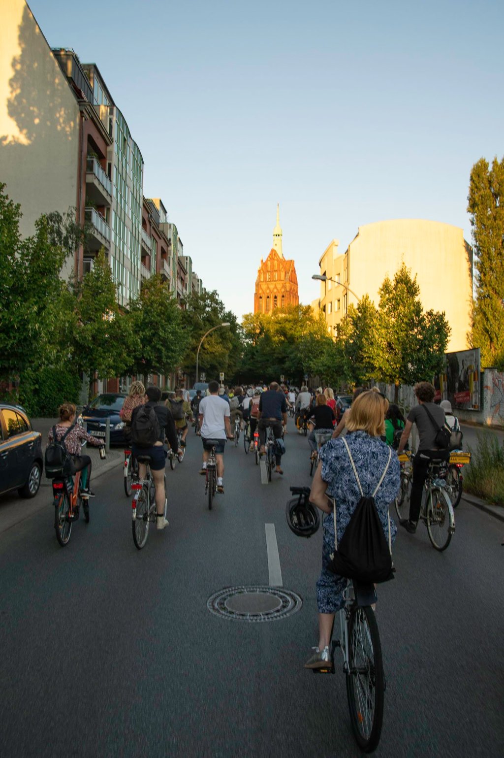 a group of people riding bikes down a street