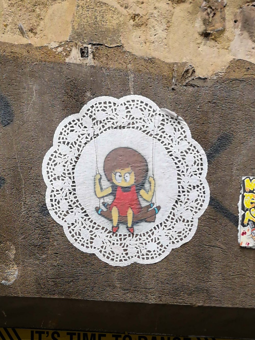 For a change, El Bocho's creature Little Lucy with not killing Kitty and enjoys her swing. Paste-Up made out of a lace-like paper table settee.