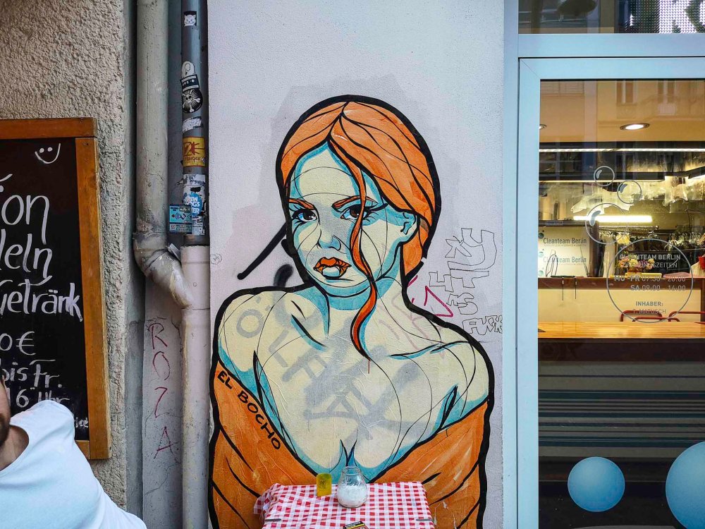 A bit provocative, isn't it, the way her cleavage opens over this table in Schönhauser Allee