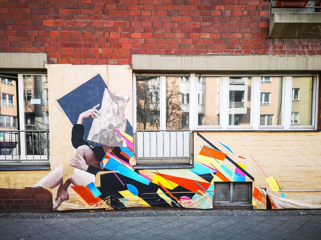 Even though I forgot to find out the artist, I love how she/he combined really huge past-ups to create an actual mural and how the medium paper is mirrired in the subject of the piece