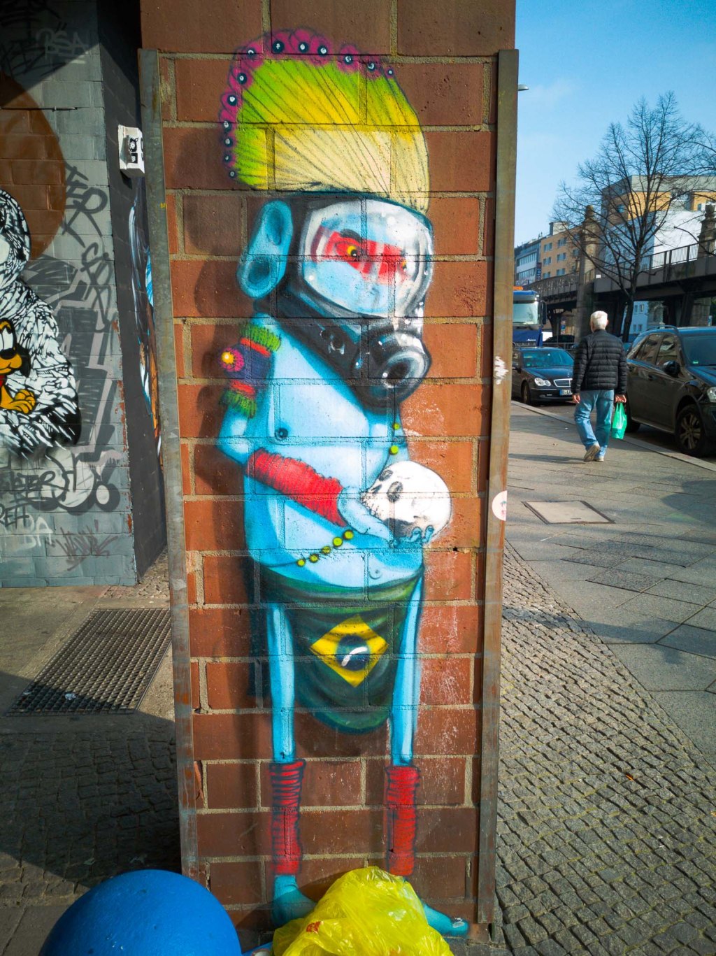 Blue Indian wearing a gas mask and a Brazilian flag as a skirt.