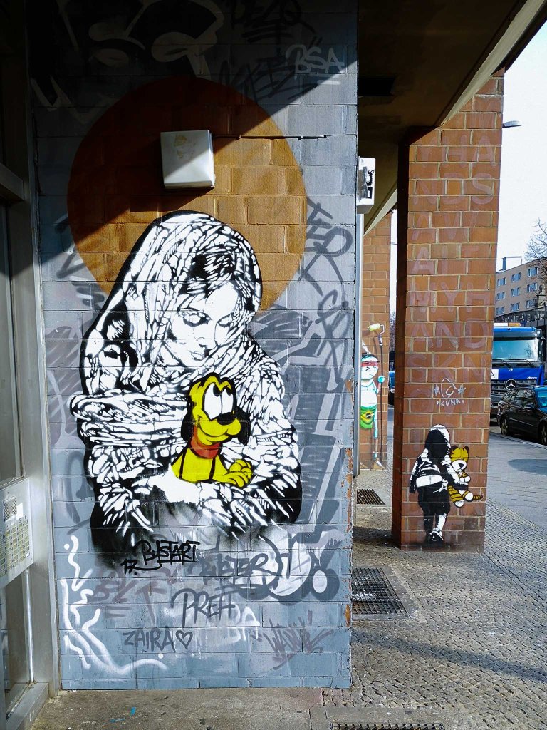 Another work by Bustart at the same location, showing the virgin Mary in black and white holding Pluto in her arms.