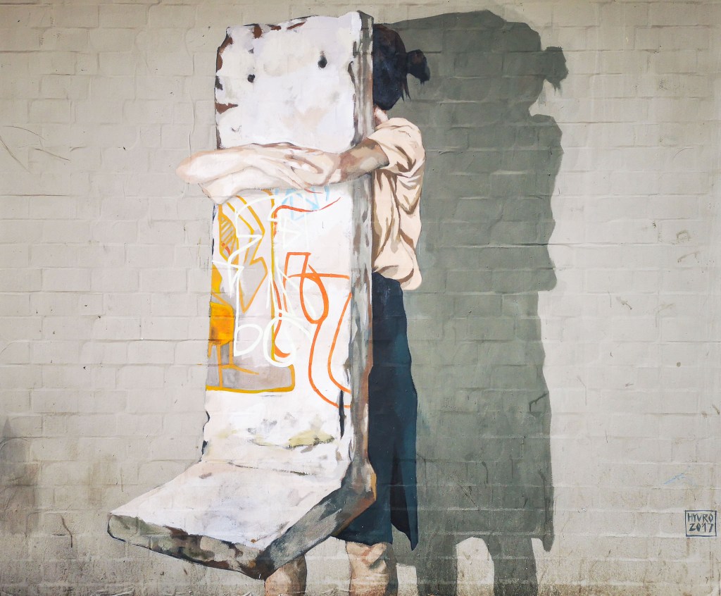 Powerful piece showing a kid hugging the Berlin Wall by enigmatic Spanish artist Hyuro - or maybe she's carrying it away, who know?