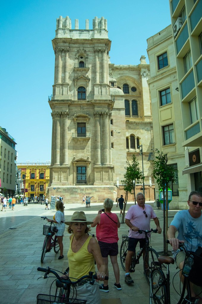 Cyclists in front of Santa Iglesia Catedral Basílica de la Encarnación, Malaga cathedral, sometimes called "La Manquita" ~ the one-armed lady.