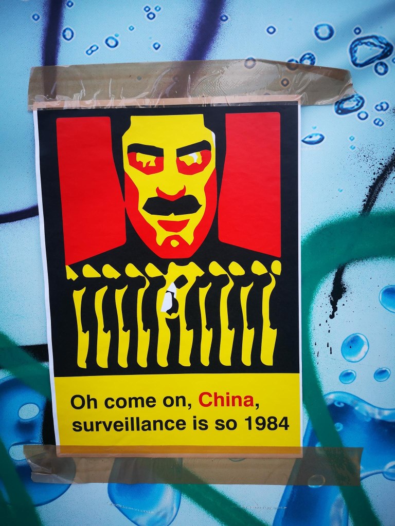 political poster on a construction site in Berlin Prenzlauer Berg sayying: Oh come on, China, surveillance is so 1984