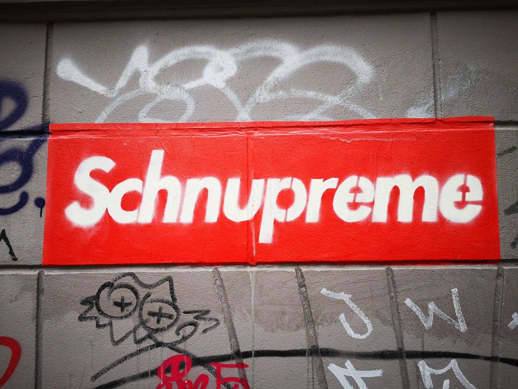 Schnupreme - white on red, paste-up - by Senor Schnu in Neukoelln's Richardstraße, Café Botanico.