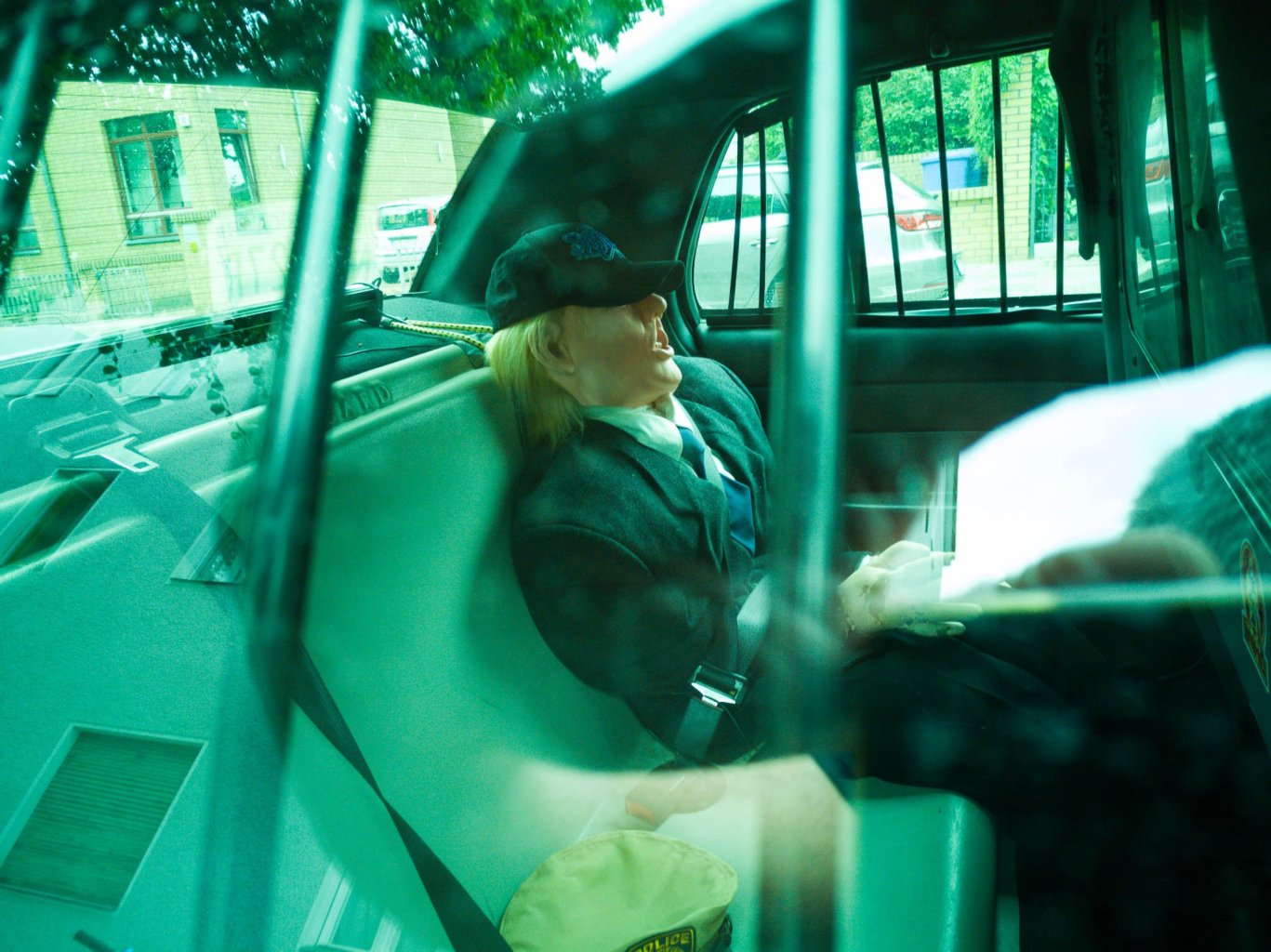Donald Trump puppet in a police car
