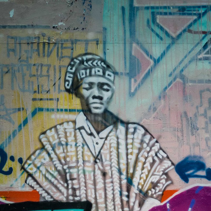 a man with graffiti on the side of a building