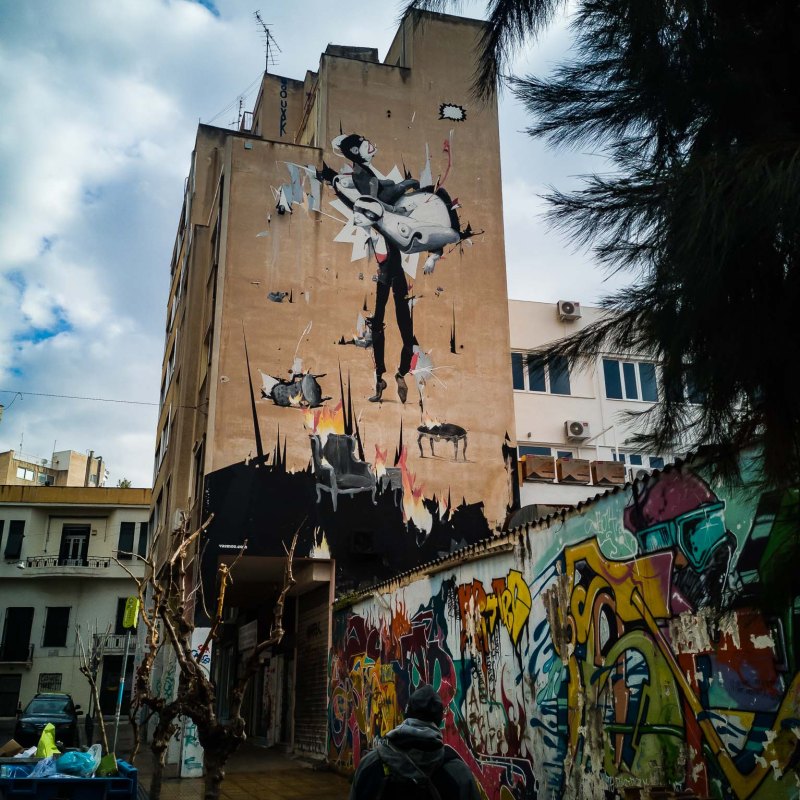 a group of people walking in front of a building