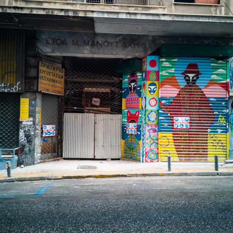 a building with graffiti on the side of a road