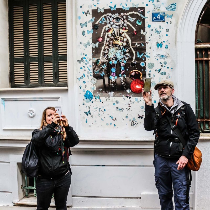 a man and a woman standing in front of a building