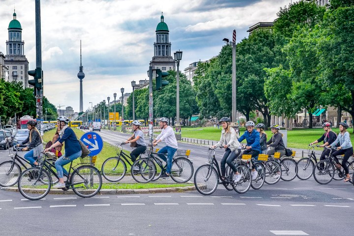 Berlin on Bike Alternative tour crossing the road in Friedrichshain, in front of Frankfurter Tor
