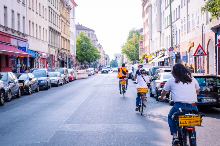 a group of people riding a bike in the Berliner Oranienstrasse