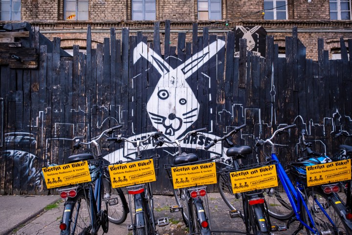 a load of bicycles parked in front of a Berlin techno club during a Berlin Bike Tour