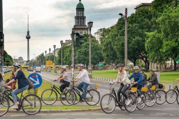 a group of people riding on the back of a bicycle