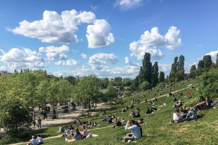 a group of people sitting in a field