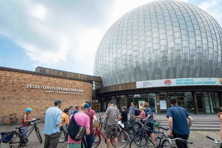 a group of people walking in front of a building