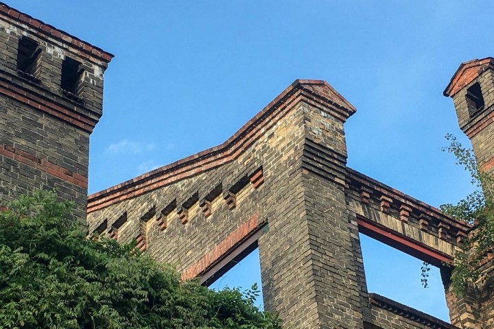 a large tall tower with a clock on the side of a building