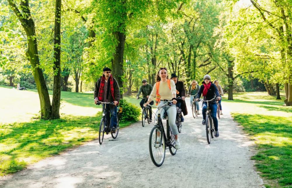 a group of people riding on the back of a bicycle