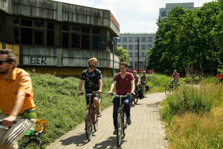 a group of people riding on the back of a bicycle