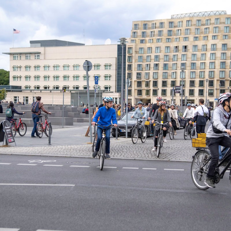 a group of people riding bikes on a city street