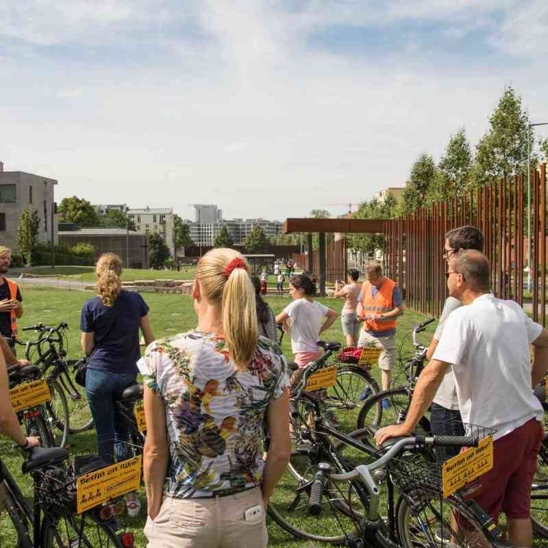 a group of people that are standing in the grass