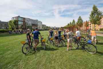 a group of people riding on the back of a bicycle