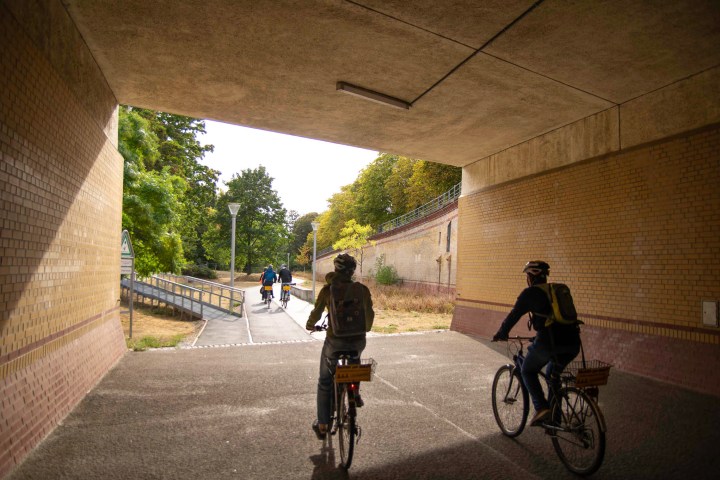 a man riding on the back of a bicycle