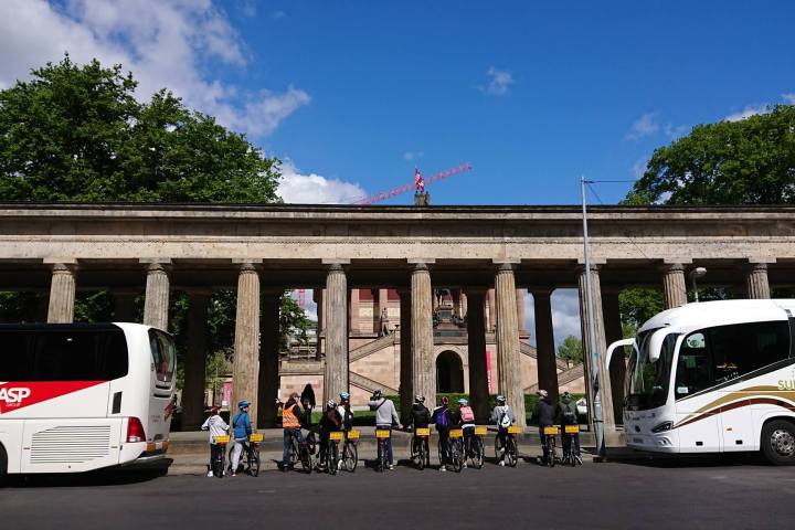 a passenger bus that is parked on the side of a building