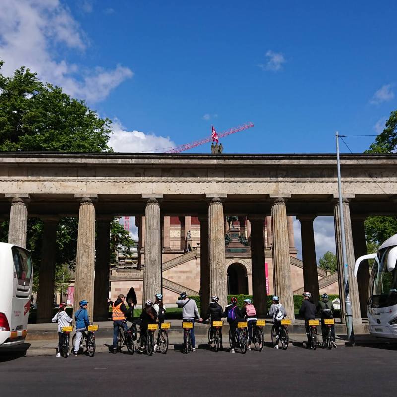 a passenger bus that is parked on the side of a building