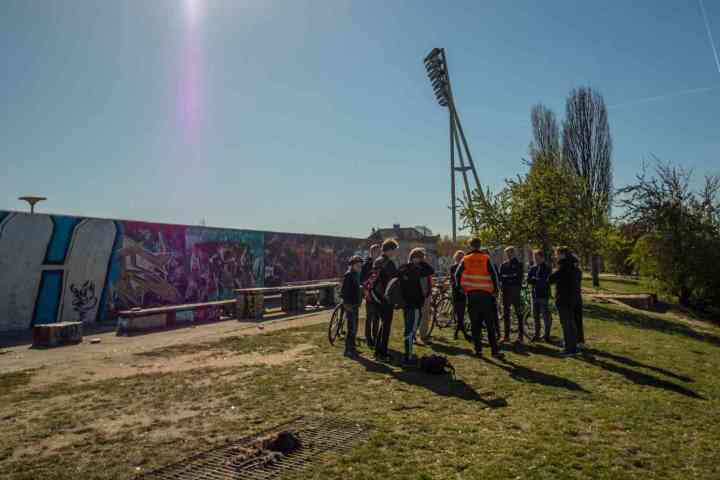 a group of people that are standing in the grass