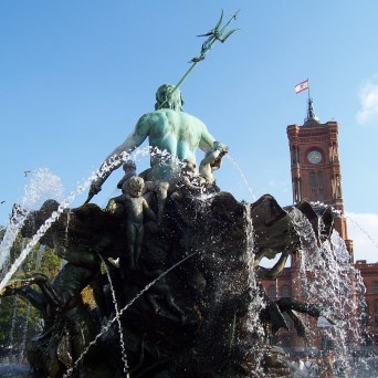 a group of people standing next to a tree