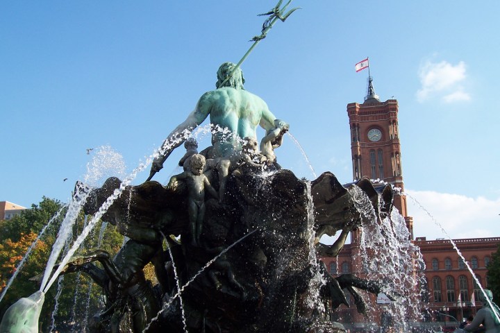 a group of people standing next to a tree