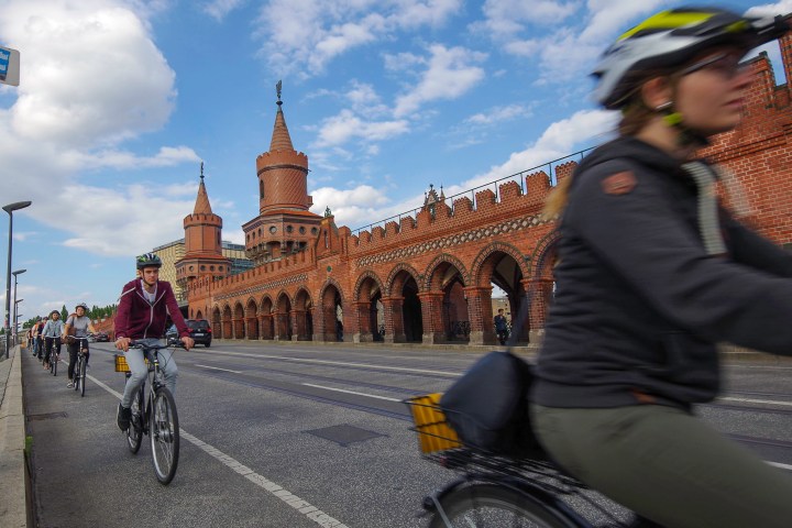 a person riding a bicycle in front of a building