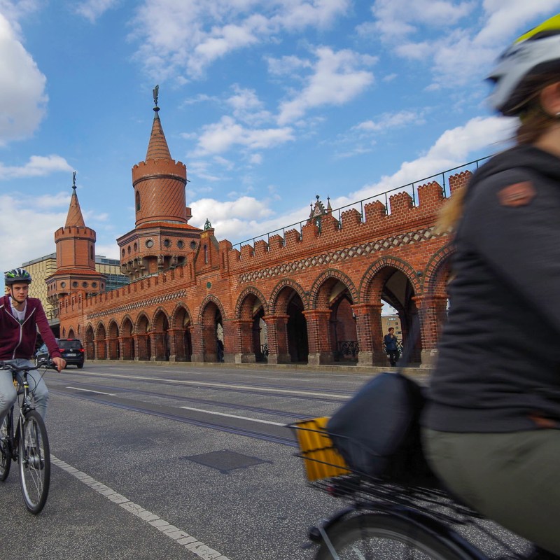 a person riding a bicycle in front of a building