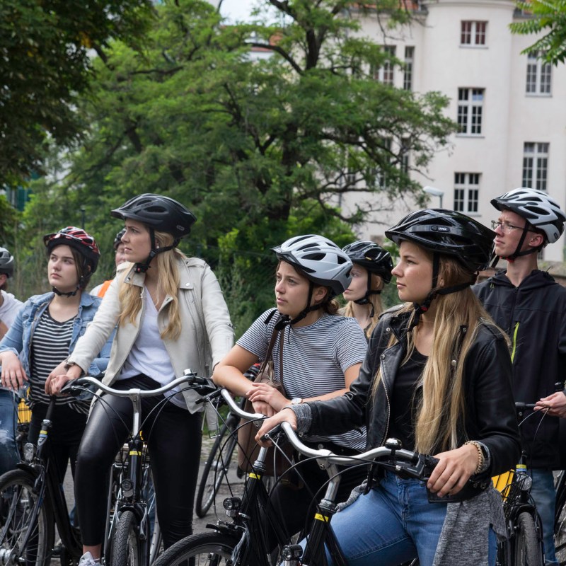 a group of people riding on the back of a bicycle