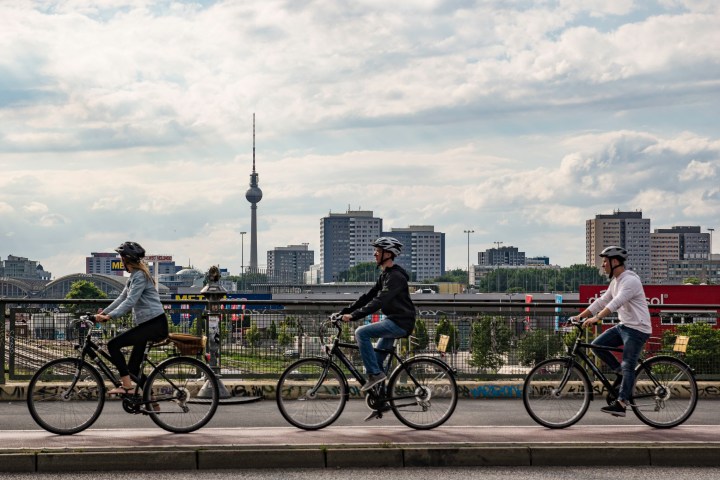 a group of people riding on the back of a bicycle
