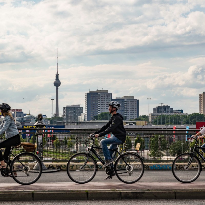 a group of people riding on the back of a bicycle