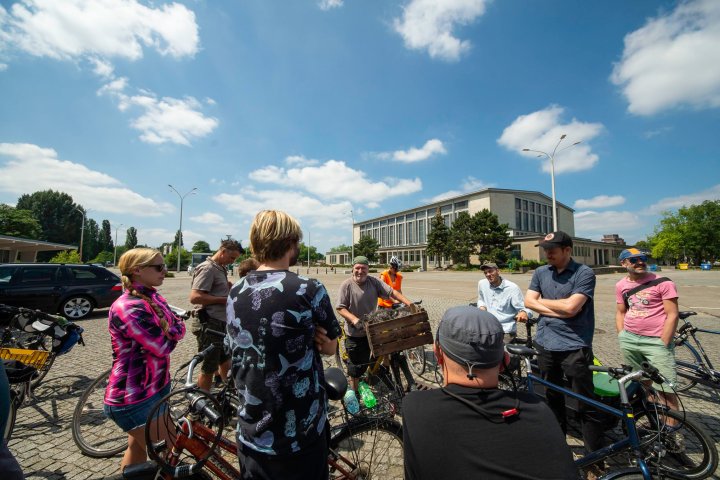 a group of people standing around a motorcycle