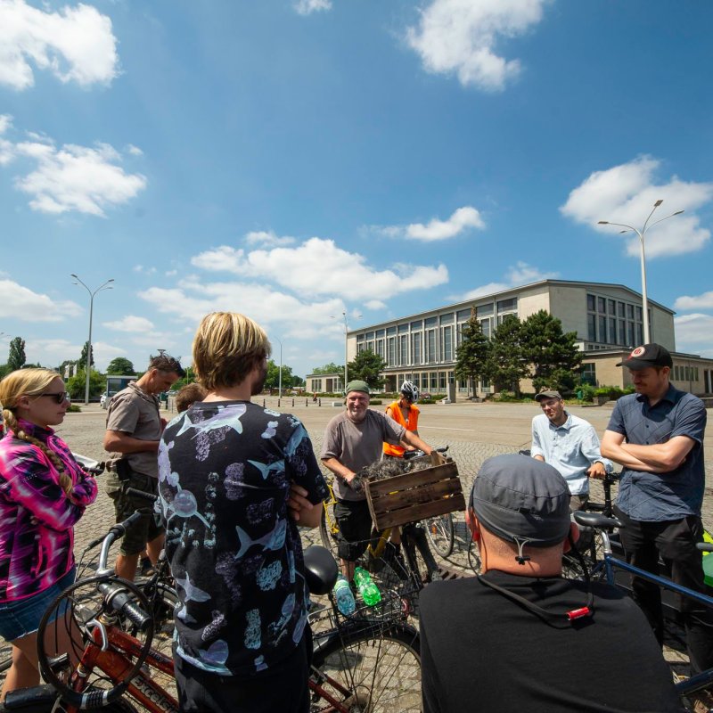 a group of people standing around a motorcycle