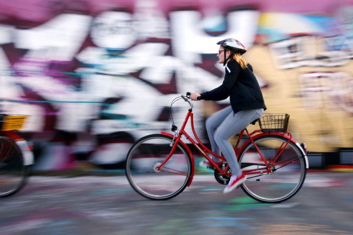 a person riding on the back of a bicycle