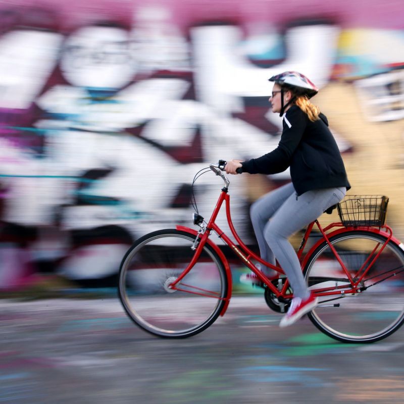 a person riding on the back of a bicycle